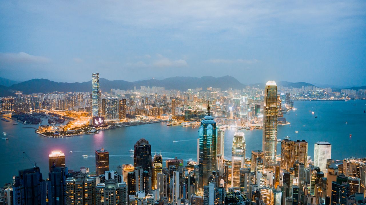 gallery-3 Explore the breathtaking skyline of Hong Kong at dusk, highlighting vibrant lights and Victoria Harbor.