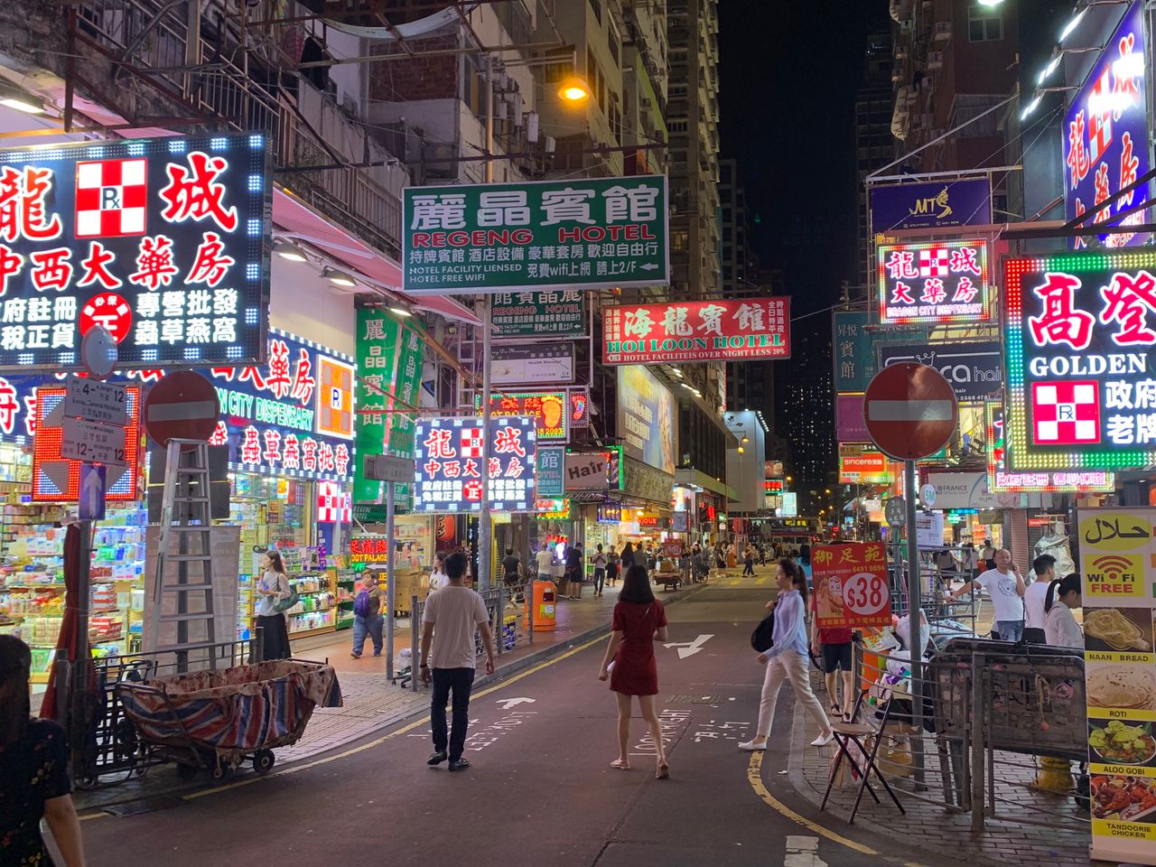 services-02 Lively night street in Hong Kong with bustling shops and neon signs.