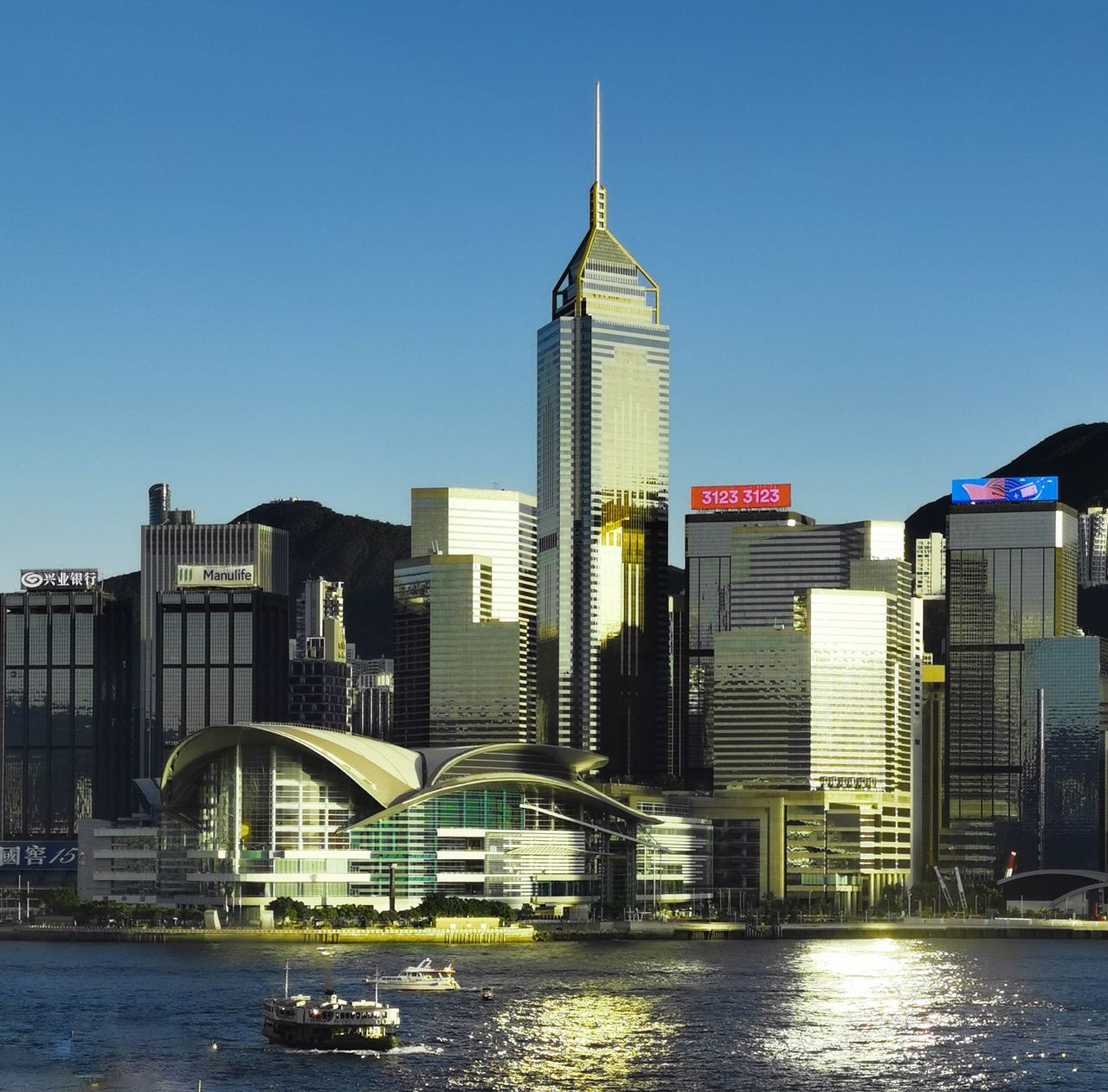 gallery-1 Stunning view of Hong Kong skyline with modern architecture and waterfront reflections at twilight.